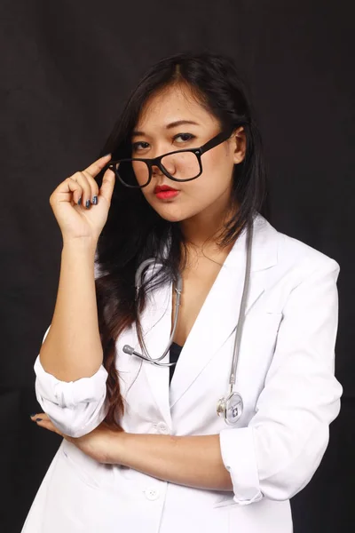 indonesia woman doctor holding stethoscope, report on white background