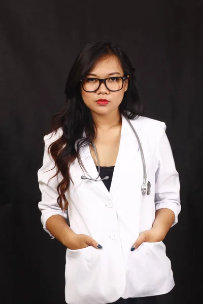 indonesia woman doctor holding stethoscope, report on white background