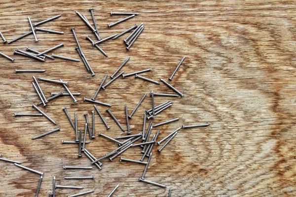 metal nails on a wooden board with empty space for text