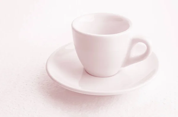 tinted in pink white coffee cup and saucer, empty coffee-free coffee cup, front view from above, or black coffee, on a white background