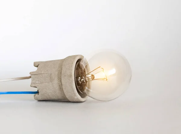 캡, 소켓, 전선이있는 조명 백열 램프 전구는 흰색 배경, 새로운 아이디어 개념에 놓여 있습니다. — 스톡 사진