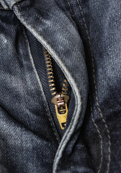 close-up zipper open on blue jeans, denim texture, zipper jeans pants