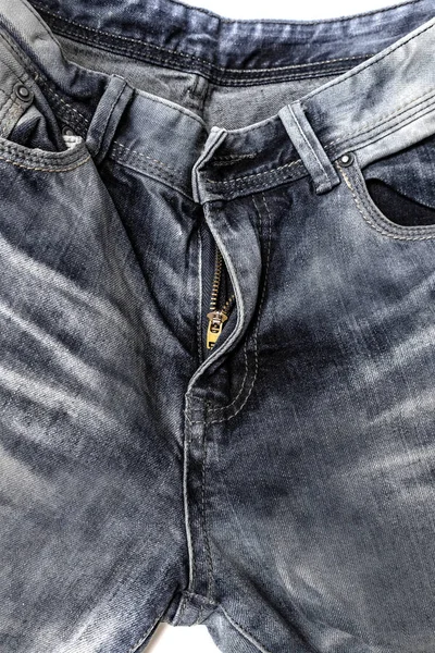 close-up denim pants, open zipper, pockets, belt loops, shabby denim fabric texture