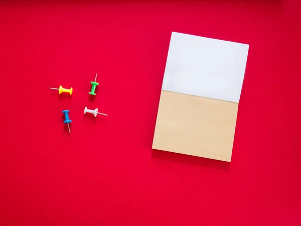 Notepad on red copy space top view — Stock Photo, Image