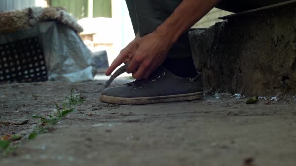 Poor Man Boy Shoelaces His Shoes Slow Motion — Stock Video
