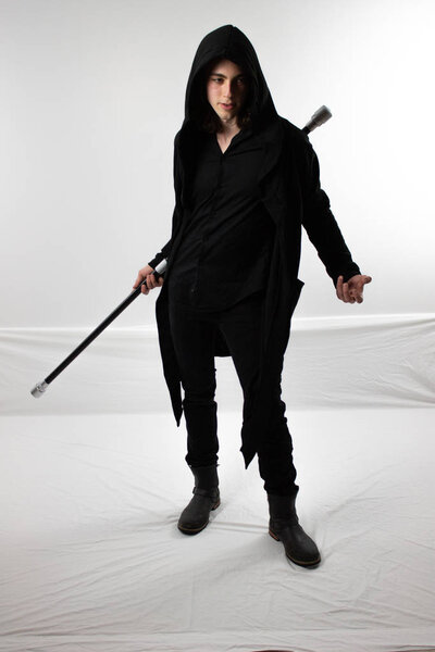 Dark warrior hunter in black hood with staff