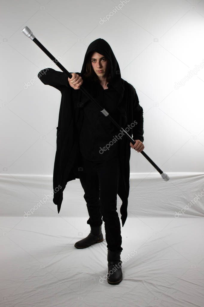 Dark warrior hunter in black hood with staff