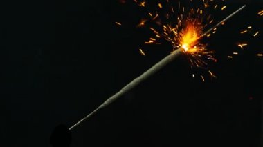 Bengal ışıklar. Bengal ateşi bir çerçeve, bir turuncu parlamayı yanar bir çapraz üzerinde bulunan bir parça. Farklı yönlere ayrı kıvılcımlar. Shooted siyah bir arka plan-ebilmek var olmak kullanılmış içinde video bir
