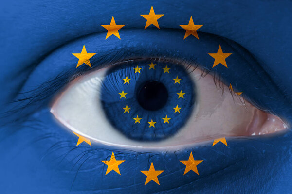 Human face painted with flag of European Union EU on the face and the iris. The concept of the eusopean view of life.