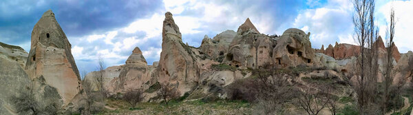 Panoramic view of the valley in Goreme village, Turkey. Rural Cappadocia landscape. Volcanic mountains in Goreme national park. Countryside lifestyle.