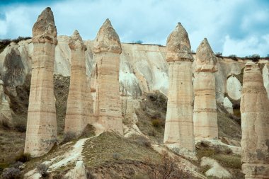 Love valley with huge phallus shape stones in Goreme village, Turkey. Rural Cappadocia landscape. Volcanic tuff mountains in Goreme national park. Countryside lifestyle.