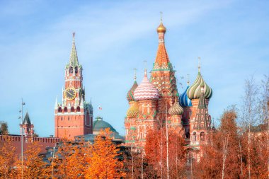 Spasskaya Tower, the Moscow Kremlin and St. Basil's Cathedral in autumn. Architecture and sights of Moscow. clipart