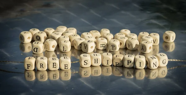 Wooden Cubes Free Shipment Inscription Strung Thread Reflective Table — Stock fotografie