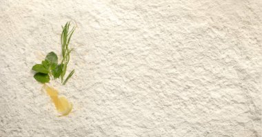 Top view of mojito ingridients on a white powder background. Lemon, mint, tarragon. Place for your menu text.