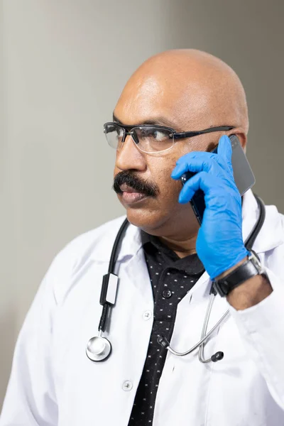 A doctor giving advice to a patient through a call due to the lock-down.