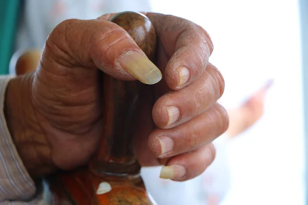 Man\'s hand with long nails holding the boat controller