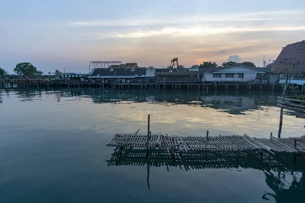 Fisherman\'s house and seaside house in Sattahip, reflecting with