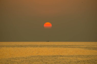 O akşam güneş düştü. Parlayan altın renk, deniz suyunu yansıtan
