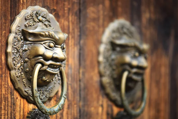 stock image ancient red doors with gilded studs and lion head door knockers closeup