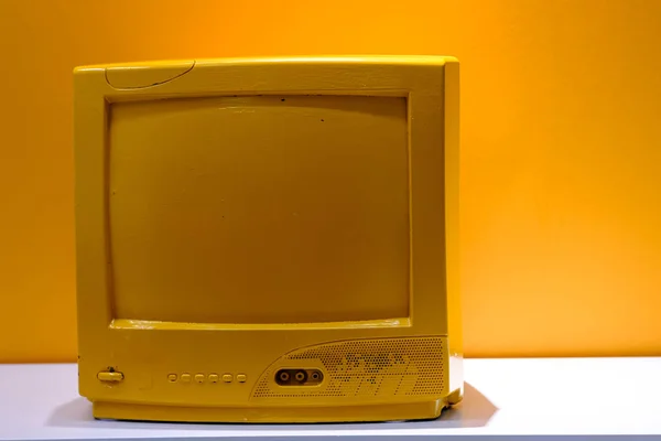 Retro old yellow TV display on table on table — Stock Photo, Image