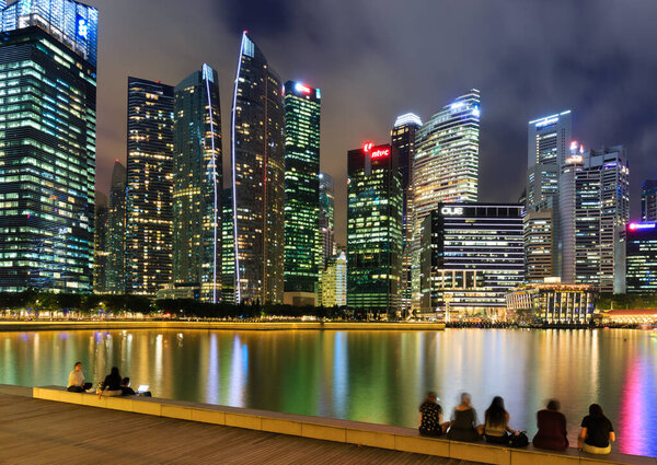 Singapore-30 APR 2018: Singapore's Central Business District, seen from across Marina Bay at night with water reflection.