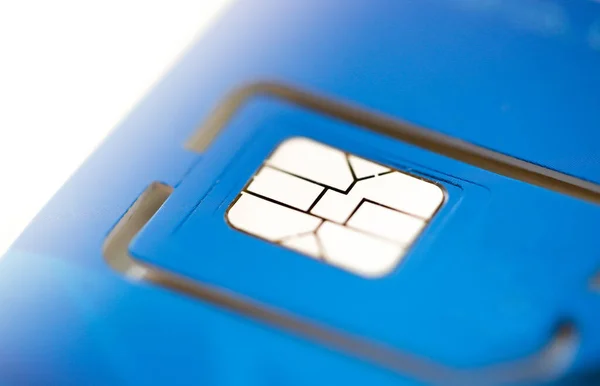 Cell phone sim card closeup view on blue plastic card — Stock Photo, Image