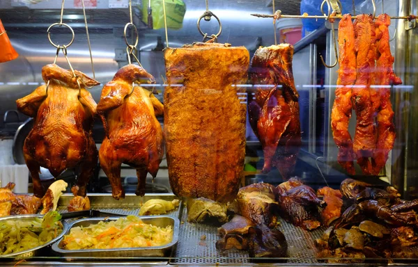 Cooked chickens and pork on display at a local food market — Stok fotoğraf