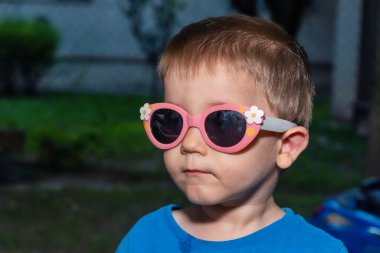 Komik güneş gözlüklü bir çocuk.