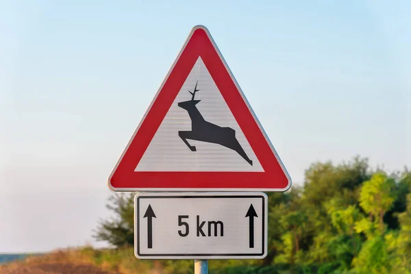 Deer Warning Sign on Country Road. Wild animals warning road sign. Deer crossing sign