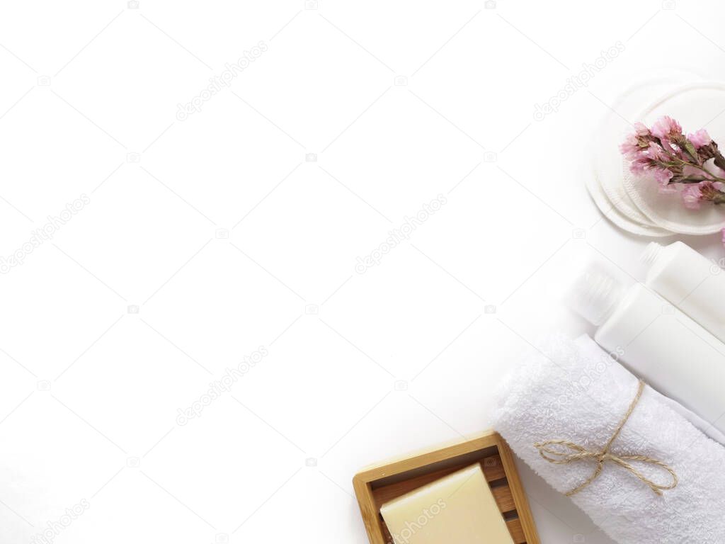 care products cream, lotion, cotton pads, plant, soap, towel. bath accessories on white background, top view, copyspace. Bodycare beauty treatments at home concept, organic products, morning routine.