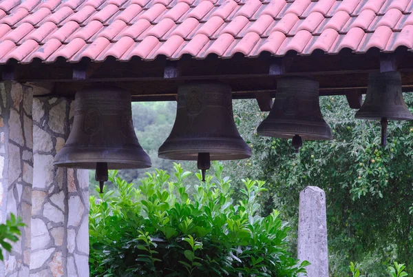 Row of old bells hanging in the garden