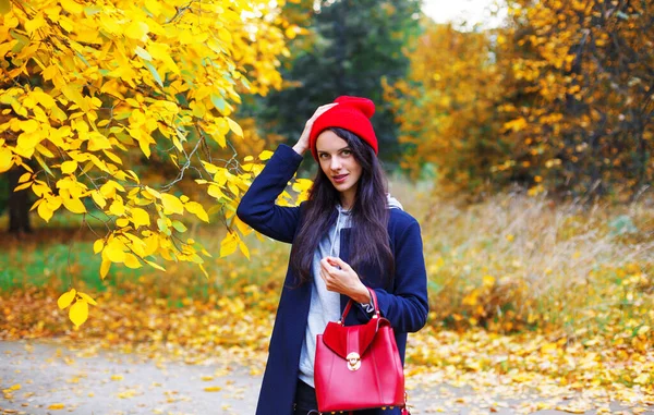 Smiling Brunette Correcting Her Red Hat Autumn Park Indian Summer — Stock Photo, Image