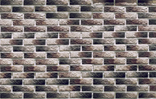 Background of masonry dark clinker bricks on the wall, which are