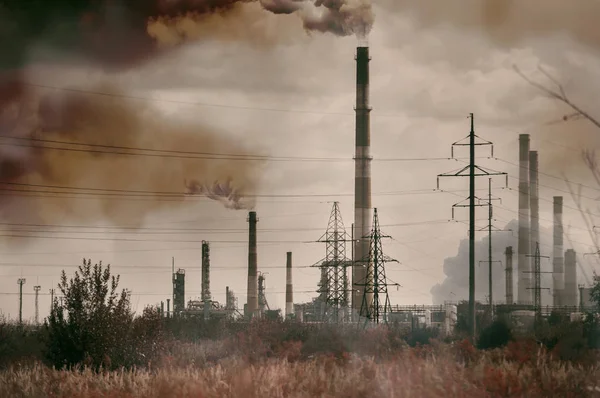 view of the refinery with high striped  pipes on a background of