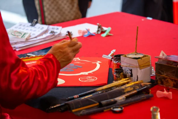 Chinese people sell their handwritten Spring Festival couplets during the Spring Festival