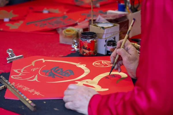 Chinese people sell their handwritten Spring Festival couplets during the Spring Festival