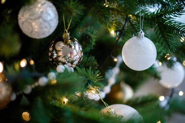 Green branches of a Christmas tree decorated with white balls Royalty Free Stock Photos
