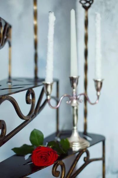 Flor de rosa roja y velas en una escalera de metal — Foto de Stock