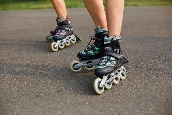 Legs of sports girls on a roller skate walk — Stock Photo, Image