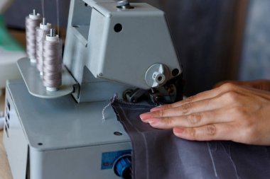 Çalışma süreci. Terzi kumaş overlok bir kenar işler