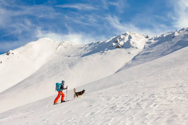 Young man backcountry skiing, going uphill on the mountain, with — 스톡 사진