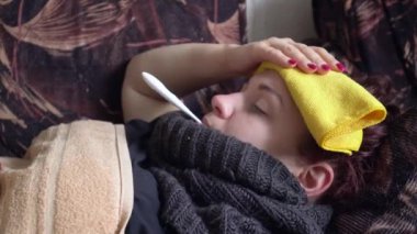 hasta Kafkas kız yatakta yatıyor ve evde termometre ile sıcaklık alır