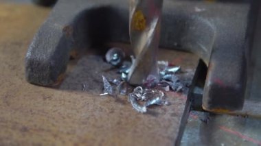 Yavaş çekimde matkap ucu, sondaj makinesi ve metal işleme ürünleri üzerinde metal işçiliği işler.