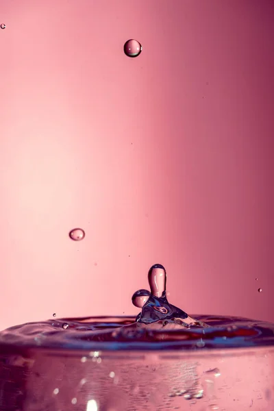 Water splash isolated on pink background