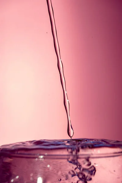 Water splash isolated on pink background