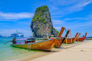 Tayland 'daki Krabi adasının tropikal sahillerinde uzun kuyruklu teknelerle güzel bir manzara..