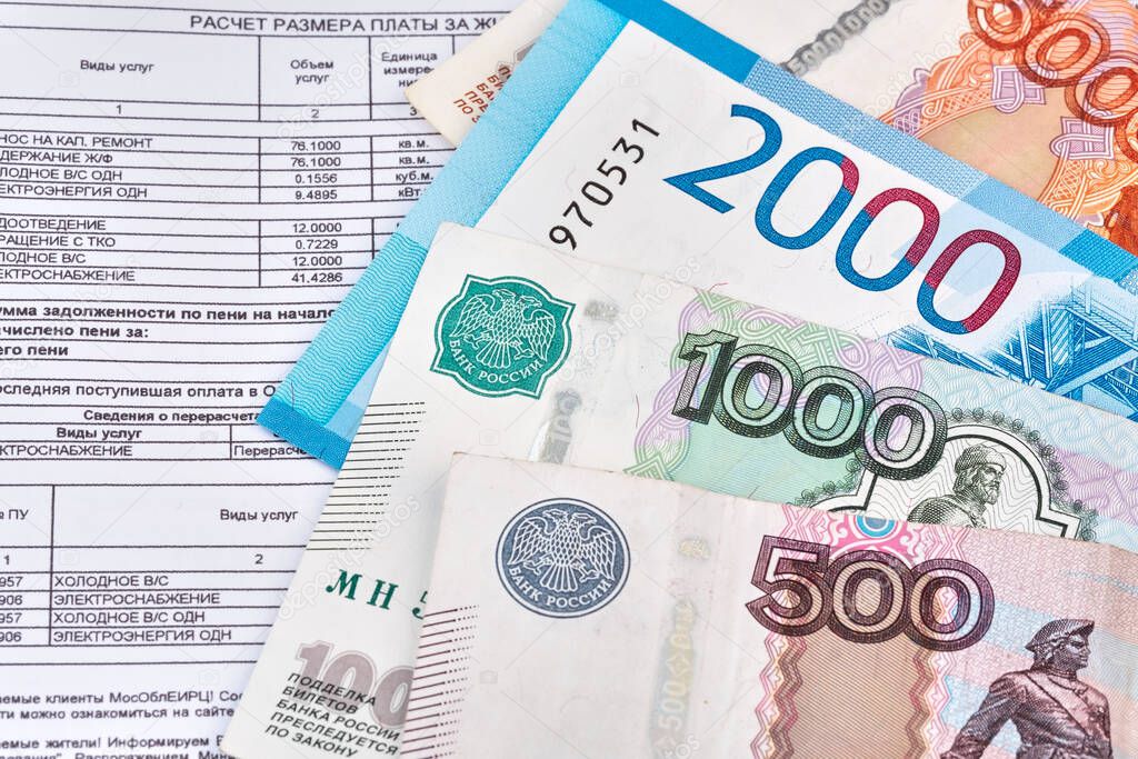 Currency in cash rubles, nominal 500, 1000, 2000 banknotes with a rent in russian bill for housing and communal services.