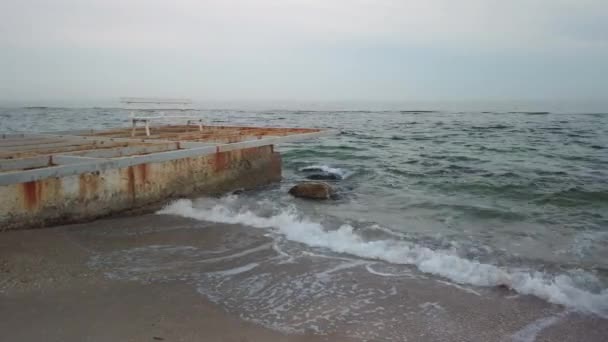 Old breakwater and empty bench - Pan — Stock Video