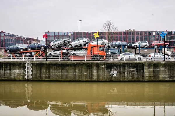 Two car shipping trailers near the channel