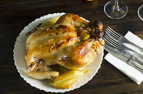 Christmas dinner. Fried chicken. Winter holiday table. Roast Turkey on a wooden background with a Christmas tree, table setting.